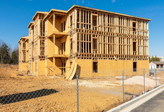 workers protected by temporary barrier fence during building maintenance in Benicia, CA